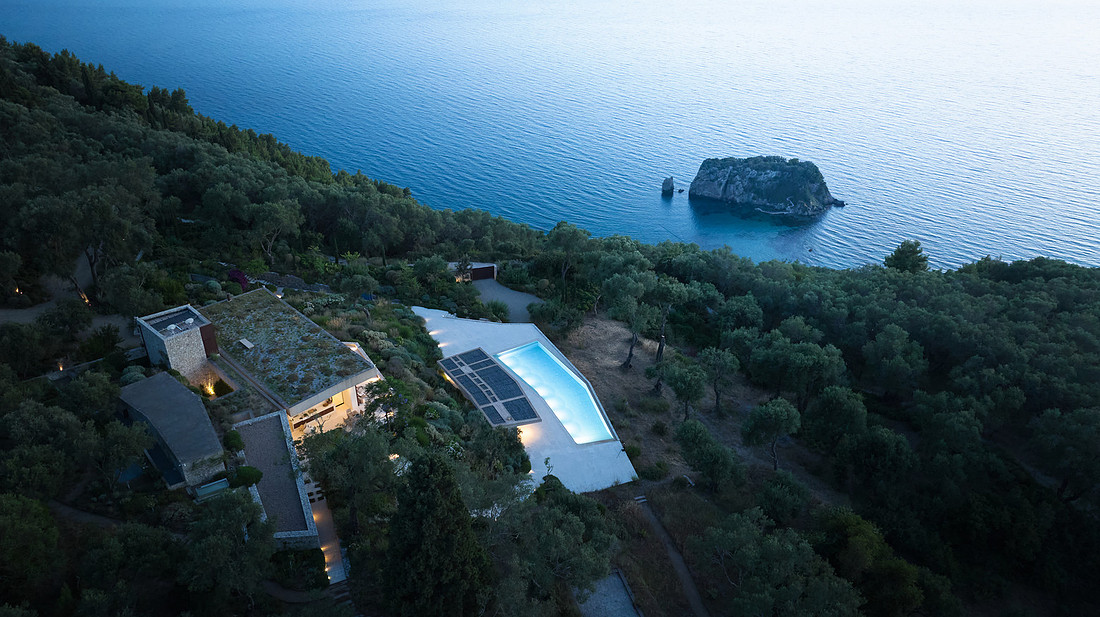 Aerial dusk view of villa, pool and coastline