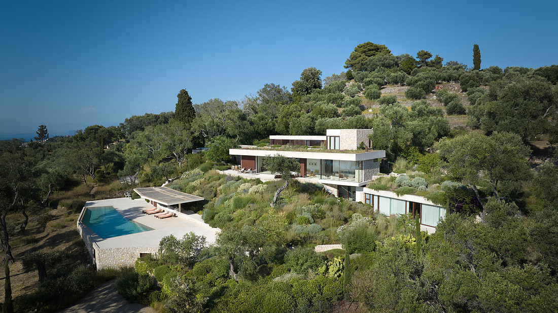 Aerial daytime view of villa on the hillside